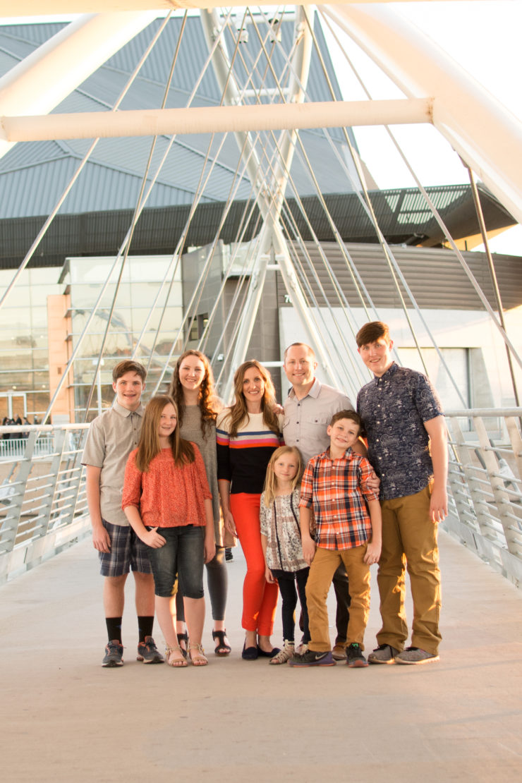 Family on pedestrian bridge at Tempe Town Lake. Photographer Melissa Maxwell of Jubilee Family Photography in Gilbert, AZ.