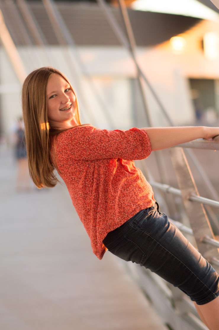 Young girl photographed on pedestrian bridge near Tempe Arts Center. Portraits by photographer Melissa Maxwell of Jubilee Family Photography in Gilbert, AZ.